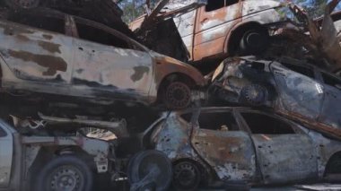 This stock video shows a dump of shot and burned cars in Irpin, Bucha district in 8K resolution