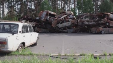 This stock video shows a dump of shot and burned cars in Irpin, Bucha district in 8K resolution