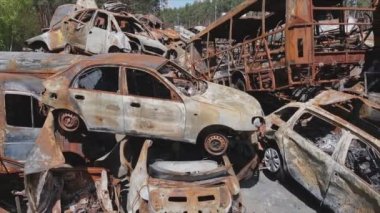 This stock video shows a dump of shot and burned cars in Irpin, Bucha district in 8K resolution
