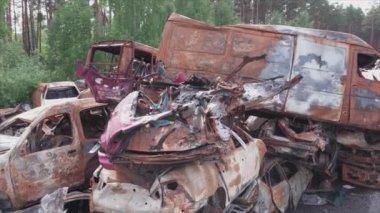 This stock video shows a dump of shot and burned cars in Irpin, Bucha district in 8K resolution