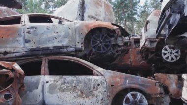 This stock video shows a dump of shot and burned cars in Irpin, Bucha district in 8K resolution