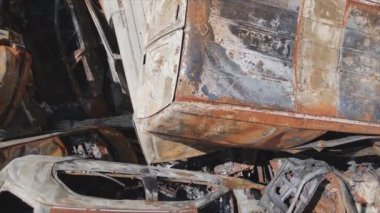This stock video shows a dump of shot and burned cars in Irpin, Bucha district in 8K resolution