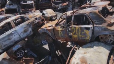 This stock video shows a dump of shot and burned cars in Irpin, Bucha district in 8K resolution