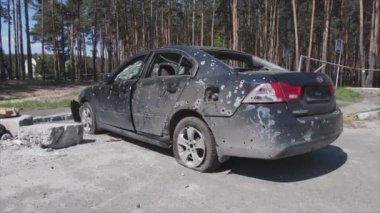 This stock video shows a dump of shot and burned cars in Irpin, Bucha district in 8K resolution