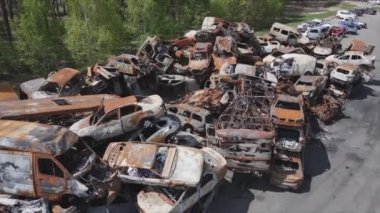 This stock video shows a dump of shot and burned cars in Irpin, Bucha district in 8K resolution