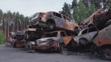 This stock video shows a dump of shot and burned cars in Irpin, Bucha district in 8K resolution