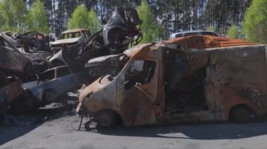 This stock video shows a dump of shot and burned cars in Irpin, Bucha district in 8K resolution