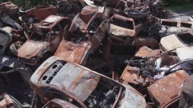 This stock video shows a dump of shot and burned cars in Irpin, Bucha district in 8K resolution