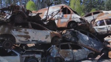 This stock video shows a dump of shot and burned cars in Irpin, Bucha district in 8K resolution