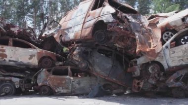 This stock video shows a dump of shot and burned cars in Irpin, Bucha district in 8K resolution