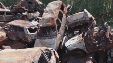 This stock video shows a dump of shot and burned cars in Irpin, Bucha district in 8K resolution