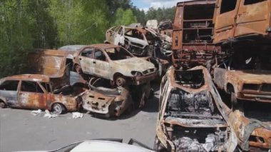 This stock video shows a dump of shot and burned cars in Irpin, Bucha district in 8K resolution