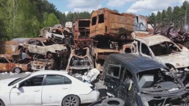 This stock video shows a dump of shot and burned cars in Irpin, Bucha district in 8K resolution