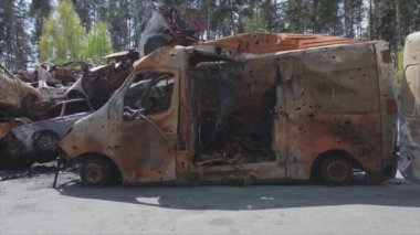 This stock video shows a dump of shot and burned cars in Irpin, Bucha district in 8K resolution