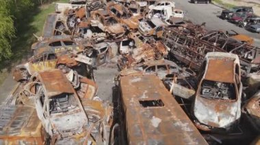 This stock video shows a dump of shot and burned cars in Irpin, Bucha district in 8K resolution