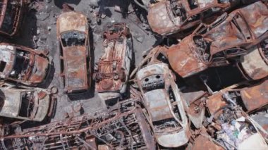This stock video shows a dump of shot and burned cars in Irpin, Bucha district in 8K resolution