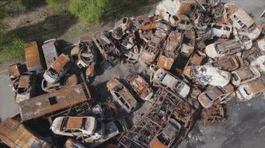 This stock video shows a dump of shot and burned cars in Irpin, Bucha district in 8K resolution