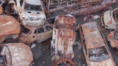 This stock video shows a dump of shot and burned cars in Irpin, Bucha district in 8K resolution