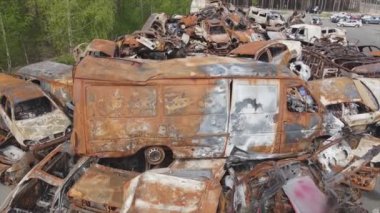 This stock video shows a dump of shot and burned cars in Irpin, Bucha district in 8K resolution