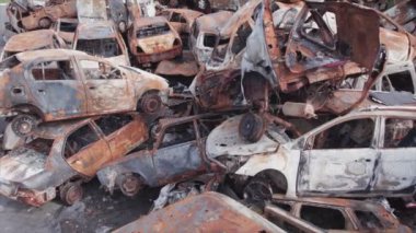 This stock video shows a dump of shot and burned cars in Irpin, Bucha district in 8K resolution