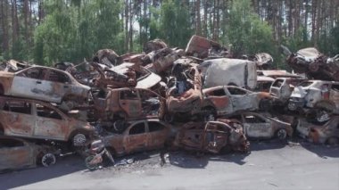 This stock video shows a dump of shot and burned cars in Irpin, Bucha district in 8K resolution