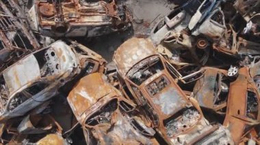 This stock video shows a dump of shot and burned cars in Irpin, Bucha district in 8K resolution