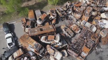 This stock video shows a dump of shot and burned cars in Irpin, Bucha district in 8K resolution