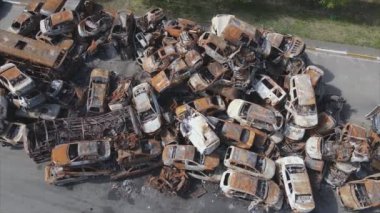 This stock video shows a dump of shot and burned cars in Irpin, Bucha district in 8K resolution