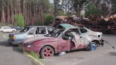 This stock video shows a dump of shot and burned cars in Irpin, Bucha district in 8K resolution