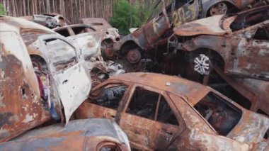 This stock video shows a dump of shot and burned cars in Irpin, Bucha district in 8K resolution