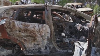 This stock video shows a dump of shot and burned cars in Irpin, Bucha district in 8K resolution