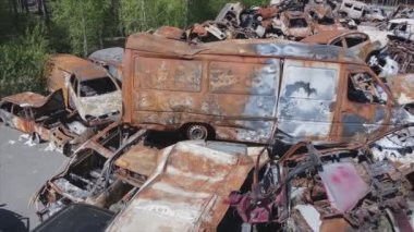 This stock video shows a dump of shot and burned cars in Irpin, Bucha district in 8K resolution