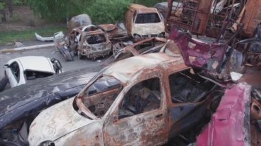 This stock video shows a dump of shot and burned cars in Irpin, Bucha district in 8K resolution