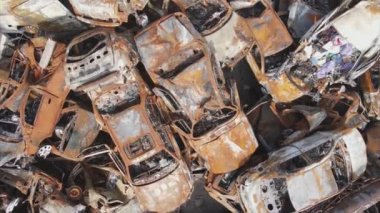 This stock video shows a dump of shot and burned cars in Irpin, Bucha district in 8K resolution