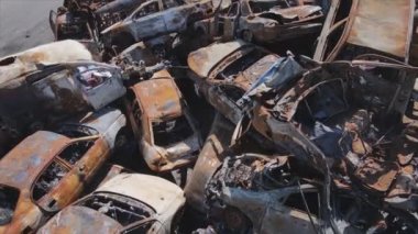 This stock video shows a dump of shot and burned cars in Irpin, Bucha district in 8K resolution