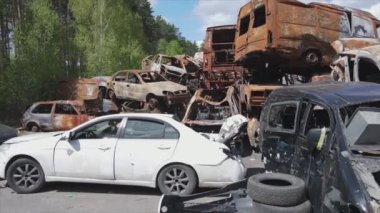 This stock video shows a dump of shot and burned cars in Irpin, Bucha district in 8K resolution