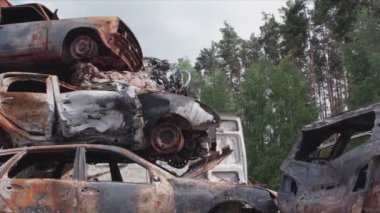 This stock video shows a dump of shot and burned cars in Irpin, Bucha district in 8K resolution