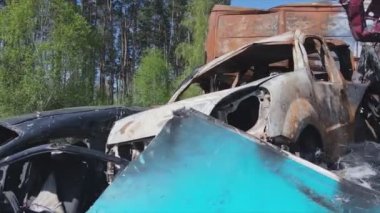 This stock video shows a dump of shot and burned cars in Irpin, Bucha district in 8K resolution
