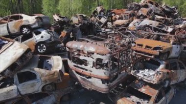 This stock video shows a dump of shot and burned cars in Irpin, Bucha district in 8K resolution