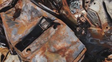 This stock video shows a dump of shot and burned cars in Irpin, Bucha district in 8K resolution