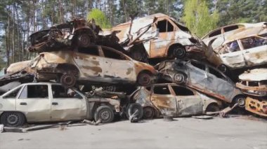 This stock video shows a dump of shot and burned cars in Irpin, Bucha district in 8K resolution