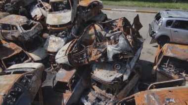 This stock video shows a dump of shot and burned cars in Irpin, Bucha district in 8K resolution