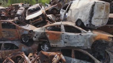 This stock video shows a dump of shot and burned cars in Irpin, Bucha district in 8K resolution