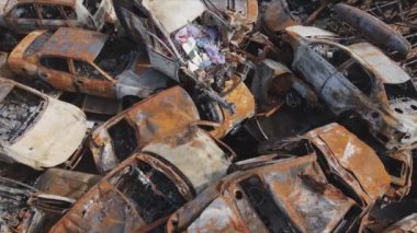 This stock video shows a dump of shot and burned cars in Irpin, Bucha district in 8K resolution
