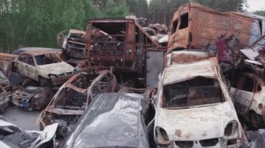 This stock video shows a dump of shot and burned cars in Irpin, Bucha district in 8K resolution