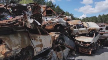 This stock video shows a dump of shot and burned cars in Irpin, Bucha district in 8K resolution
