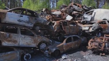 This stock video shows a dump of shot and burned cars in Irpin, Bucha district in 8K resolution