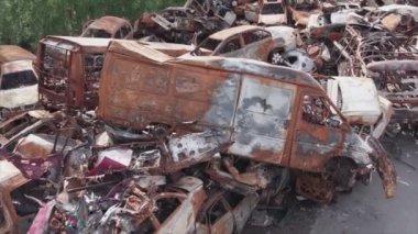 This stock video shows a dump of shot and burned cars in Irpin, Bucha district in 8K resolution