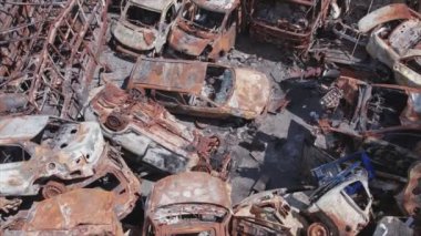 This stock video shows a dump of shot and burned cars in Irpin, Bucha district in 8K resolution
