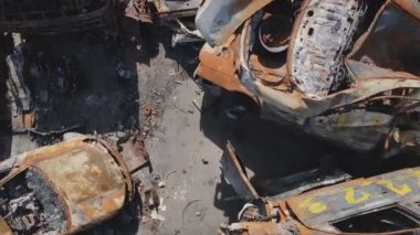This stock video shows a dump of shot and burned cars in Irpin, Bucha district in 8K resolution